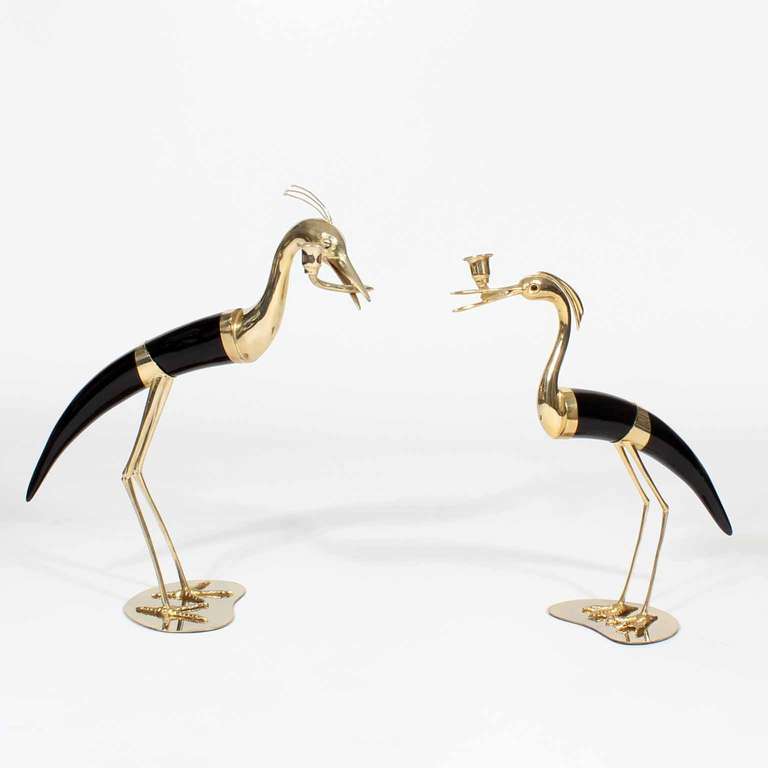 In the manner of Binazzi, this pair of faux Horn and gold metal heron or bird candlesticks, are illegibly signed on the base of each bird. Great form with candle cup holding beaks, these birds would be dramatic in any setting.
Measurements are for
