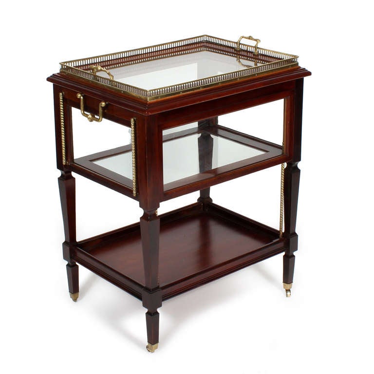 An early 20th century, brass and mahogany dessert cart or teal trolley, with three flip up  down glass doors, perfect for displaying those tempting treats. A fourth door is missing, which makes access to the rear of the trolley easier. A removeable