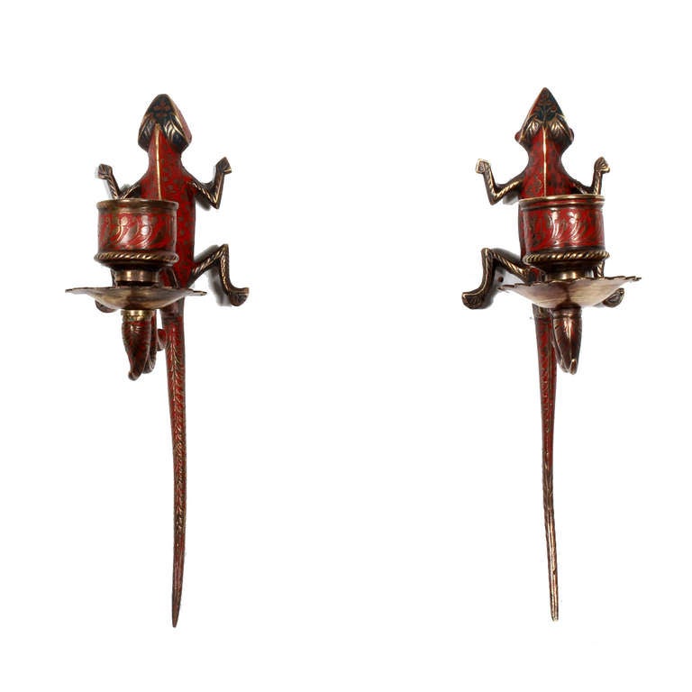 A small but sweet pair of etched and painted red lizard wall sconces, perfect for that dark space, that needs something both humorous, lucky and light casting. 
Lizards are a good-luck signs, they are a symbol for good vision and protection against