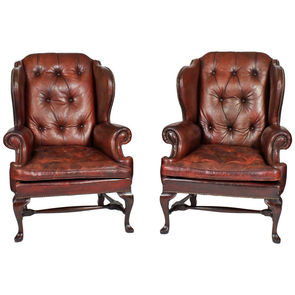 Pair of Early 20th Century Brass Tacked Tufted Leather High Back Wing Chairs