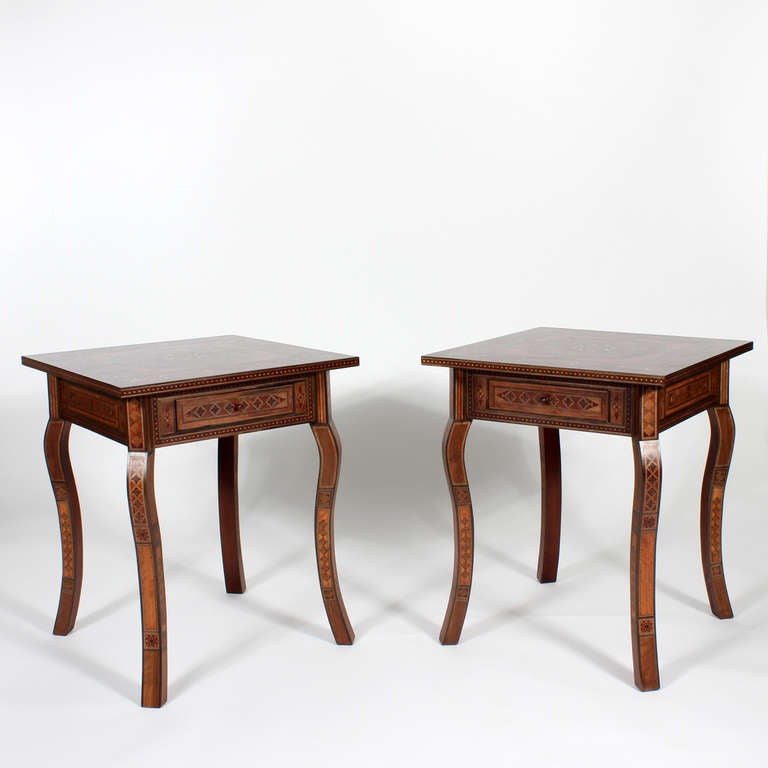 A pair of one-drawer tables, with well developed cabriole legs and intricate inlay in the Syrian manner fabricated with of exotic wood and bone. Great size, with a beautiful finish, these tables will add a pop of Orientalist decor.