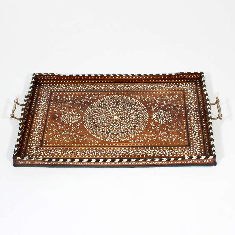 A wonderful inlaid bone and ebony Anglo Indian rosewood tray, with an inlaid central circle flanked by arabesque and foliate designs, all in a rectangular ebony inlaid rectangle, surrounded by a chevron pattern bone and ebony dovetailed rim, with
