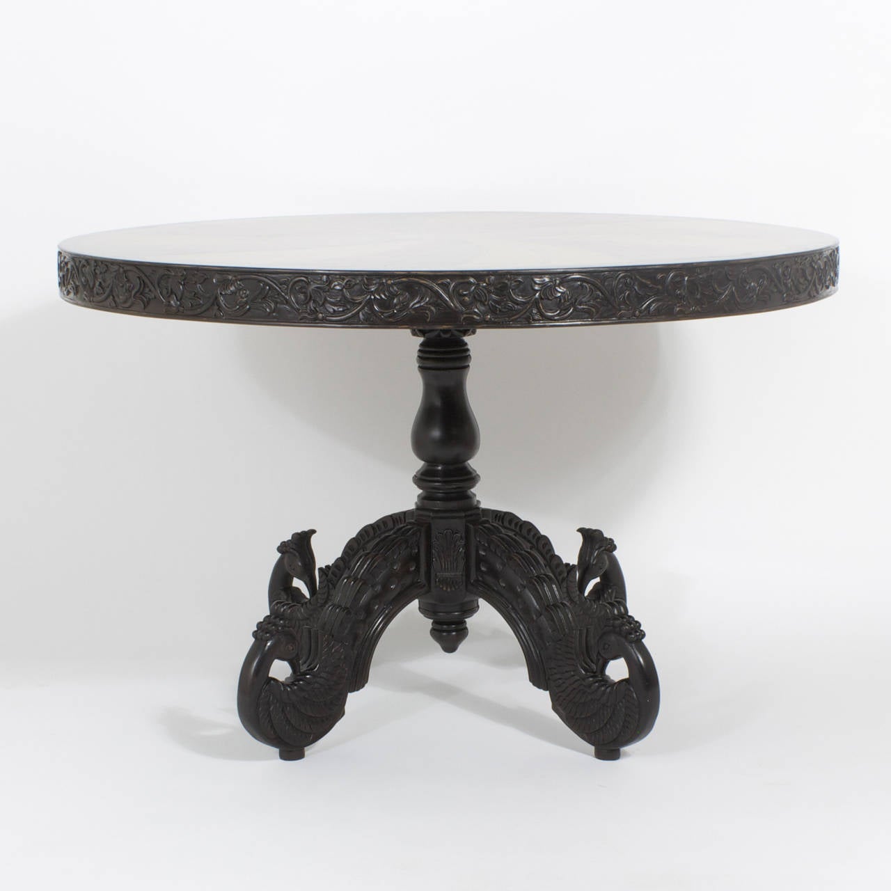 Rare and fine example of an Anglo-Indian round specimen centre table with the prerequisite exotic wood inlay in a pin wheel pattern on the top. Top band is carved wood with vines and flowers. Having a single pedestal base and four carved and splayed