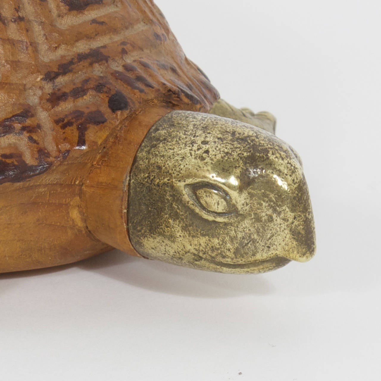 Sarreid turtle carved from a single block of exotic wood to create a life like turtle shell.  The legs, head and tail are made of Brass and make an intriguing blend of colors and textures. Slow and steady wins the race.