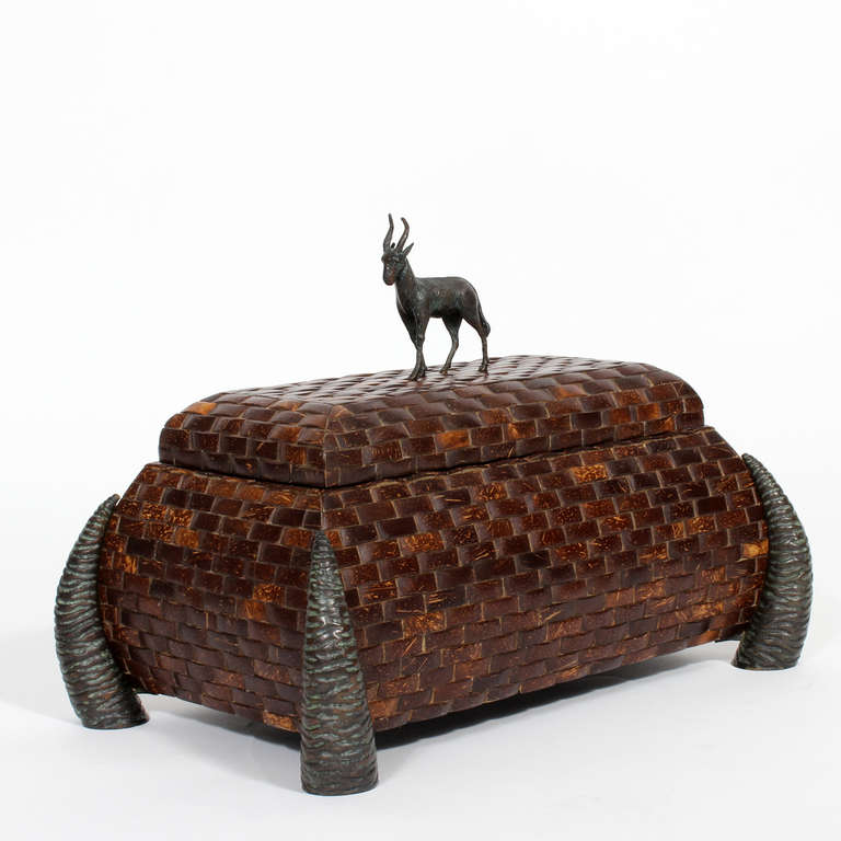 A coconut block box with stylized horn feet and a very sculptural goat figure all in bronze. Signed Maitland-Smith handmade in the Philippines.
A handsome and strong piece.

