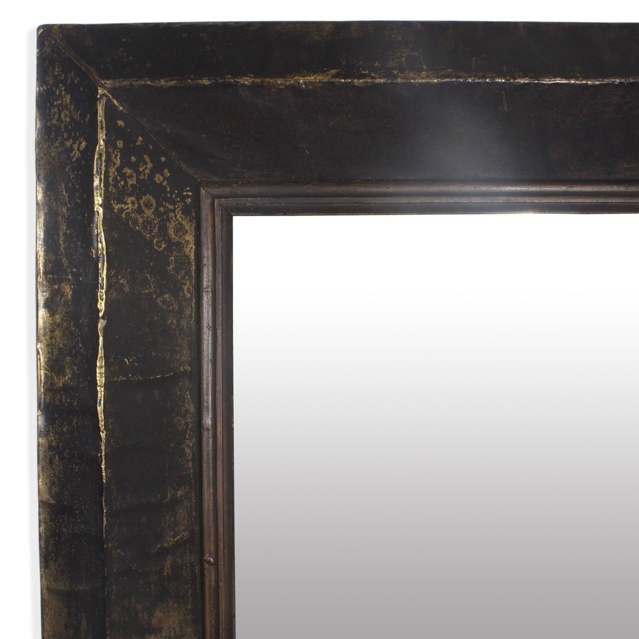 An usual rectangular mirror set in a rustic brass wrapped frame which has achieved a warm, rich patina that looks like distressed leather. Original beveled glass with acquired charm. Includes strong architectural lines and can be hung horizontally