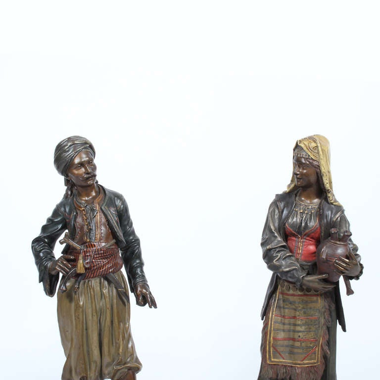 A pair of large and exceptional Orientalist cold painted spelter male and female figures, each on a raised circular base.  The size, color, form, and paint on these figures are outstanding.