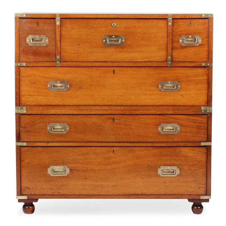 An excellent 19th C. mahogany 2 part campaign chest, with a drop down drawer, the interior fitted with reeded and ebonized birdseye maple drawers, pidgeon holes and a gilt tooled leather writing inset; wonderful drawer configuration and a turned