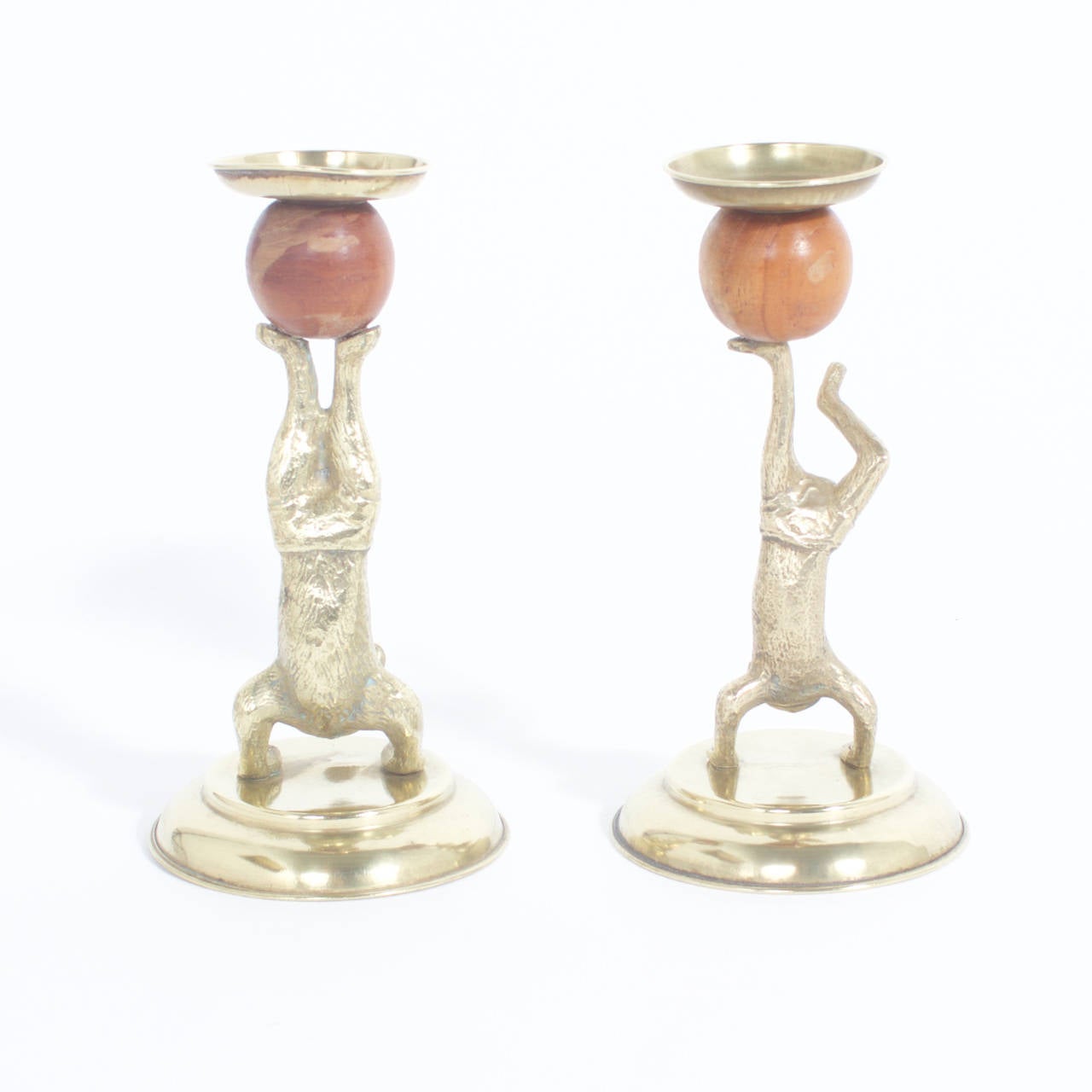 Arthur Court midcentury brass figurative candlesticks depicting a cat and a monkey in swimming trunks in a circus pose balancing a wooden ball on their feet. Signed Arthur Court designs 1977 on the bottom. Newly polished.