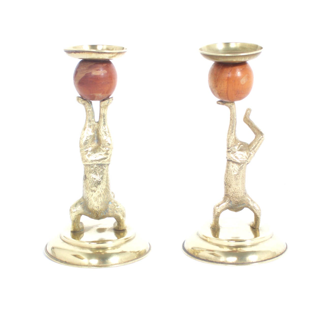 Arthur Court candlesticks depicting a dog and a cat in swimming trunks and a circus pose while balancing a wooden ball on their feet. Signed Arthur Court designs, 1977 on the bottom. Newly polished.
