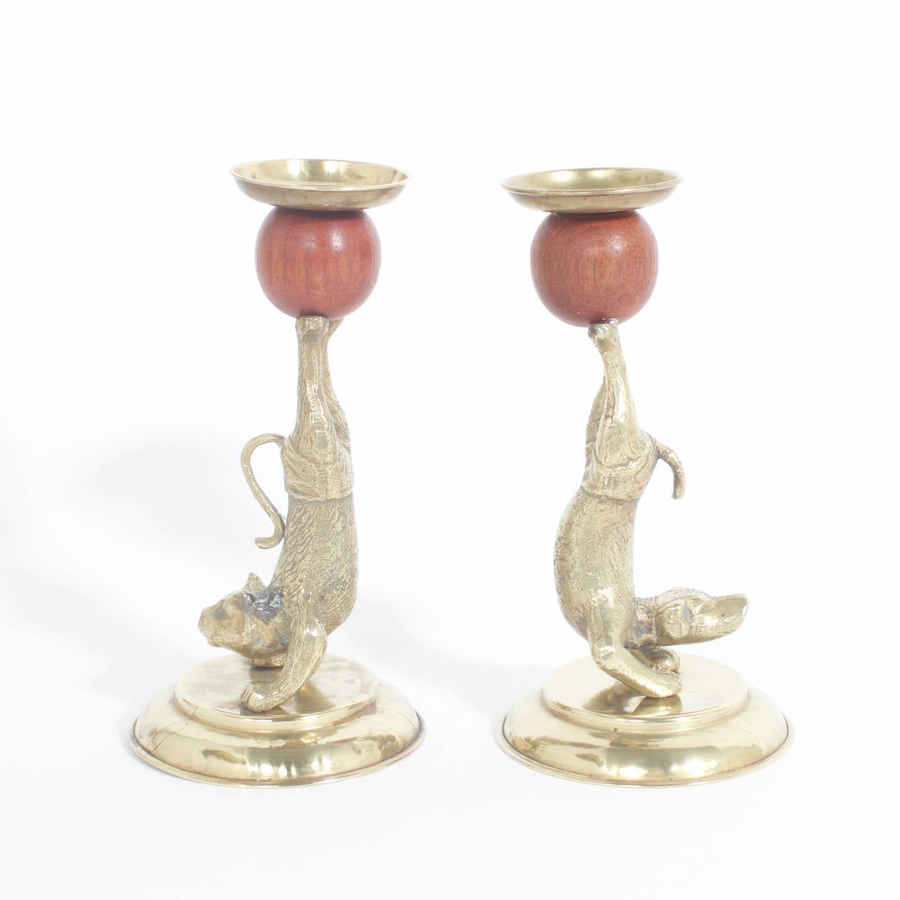 Arthur Court Mid Century Brass figurative candle sticks depicting a dog and a cat in swimming trunks while in a circus pose and balancing a wooden ball on their feet. Signed Arthur Court designs 1977 on the bottom. Newly Polished
