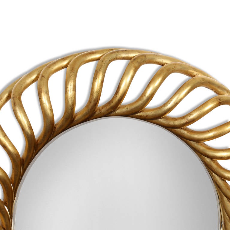 A large round mirror with a wonderful gilded wood frame carved in a repeated twisting pattern, adding a play of depth and shadows to the wall. Excellent gilding, with just the right amount of boule showing through the surface. Will be an important