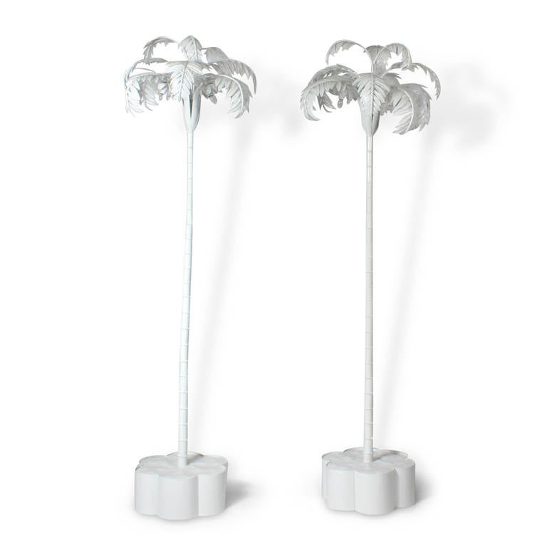 A rare pair of white painted, tole palm tree floor lamps, virtually made by hand, these floor lamps are simple, elegant yet substantial. Bring a slice of Palm Beach whimsy to your home. Newly painted and wired. Base diameter is 17