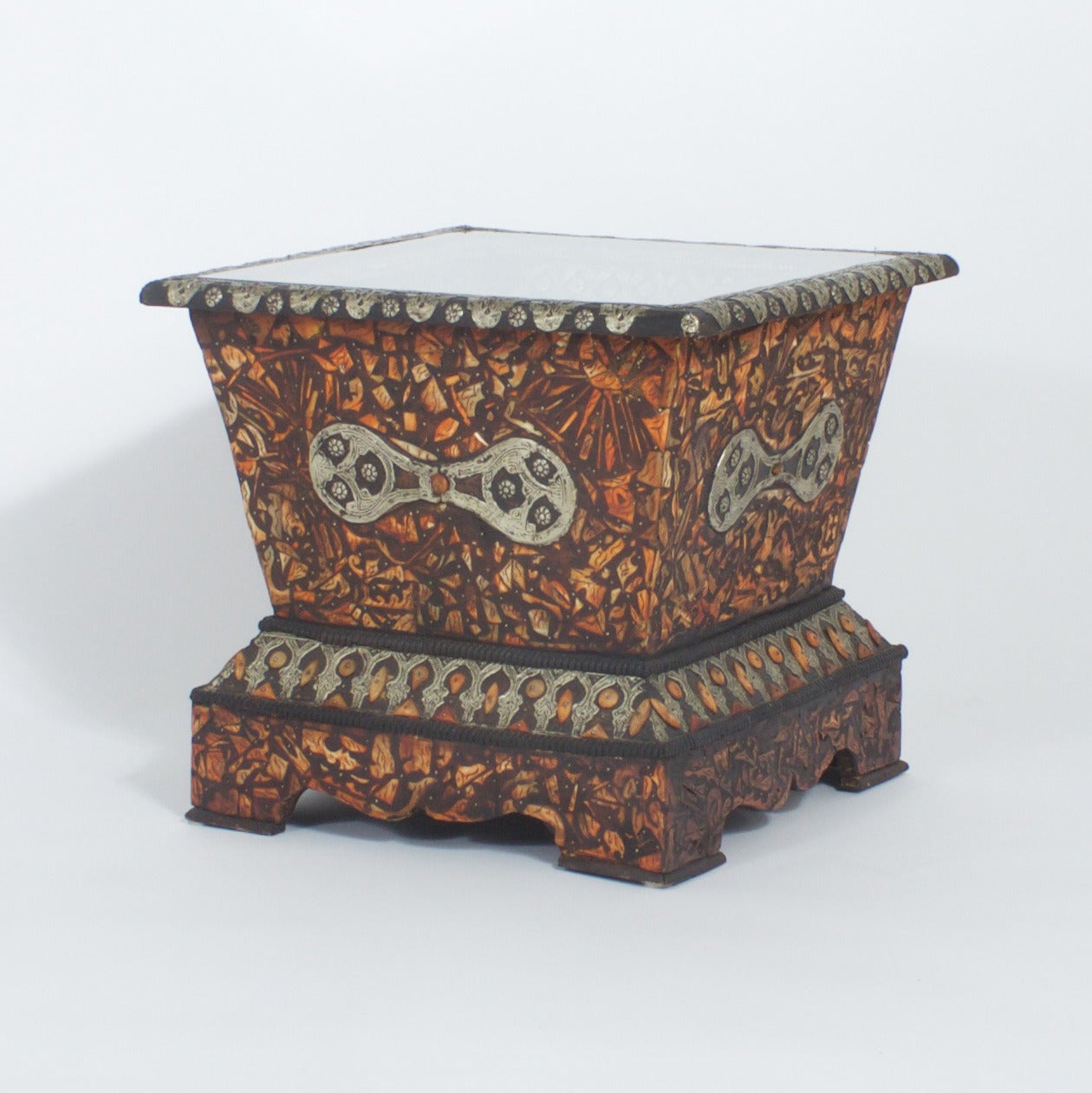 Pair of Midcentury Moroccan end tables with classical form. Decorated in an elaborate mixture of bone and silvered metal. The tops are covered in glass and reveal a large cut out of negative space with the same geometric patterns of Inlaid bone,