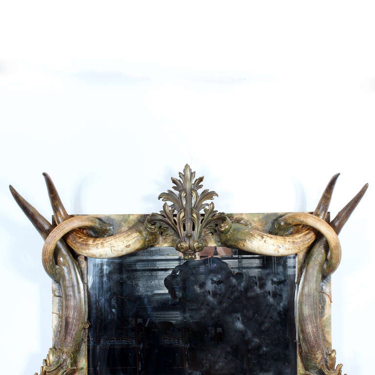 An amazing mirror designed and made by Michel Haillard of France for an upscale Colorado lodge. Intertwining horns, with bronze and ormolu fittings, combine in a masterful design to create this rustic, Louis XV or Baroque style mirror. A simply