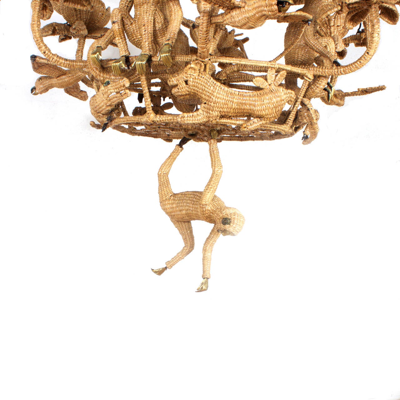 Mario Torres who is known for his whimsical wicker creations went all out with this six-light jungle chandelier. Featuring palm fronds, brass faced monkeys, toucans, cats, parrots, and alligators that are all assembled in one delightful composition.