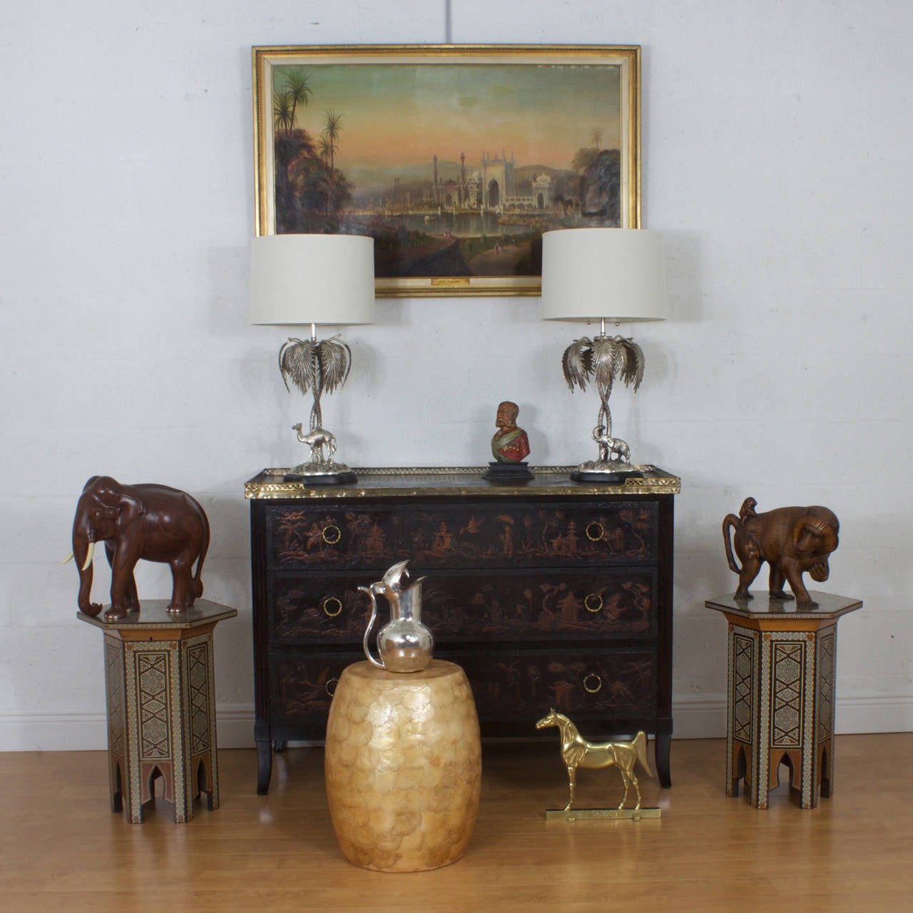 Pair of silvered metal table lamps with exotic tropical compositions that both have stylized palm trees on terra firma and one lamp with an Elephant and one with a Camel. Featuring bases and presented on biomorphic and ebonized plinths. Newly wired.