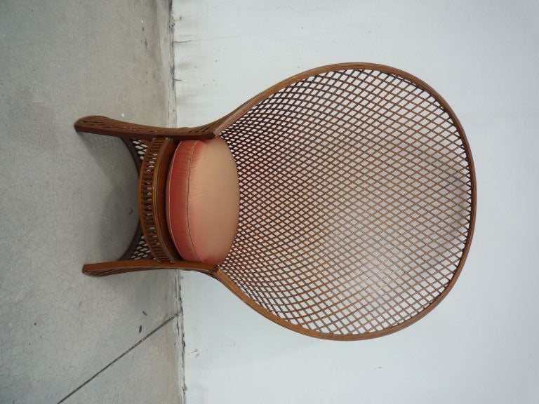 A pair of large and exceptional fan back lattice work wood McGuire lattice fan chairs, although the shape of the chairs is associated with wicker or rattan, these chairs are wood strips, held with brass nails, with great original varnish.   Although