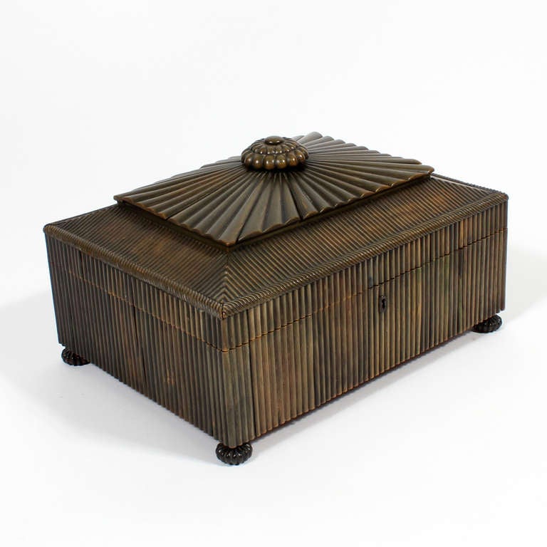 A rare early Anglo Indian bone sewing box with a radially inlaid cover panel terminating with a turned bone finial, ribbed bone sides and ends, on turned feet. Mutli compartment interior with inlaid ivory and sandalwood lids. Rare and early, with a