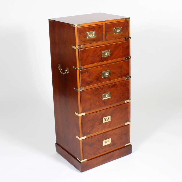 A seven drawer campaign chest in one piece with carrying handles, campaign hardware and a plinth base. Probably pear wood. Wonderful lines, with great brass strapping.
Stamped Ethan Allen. Made in England.