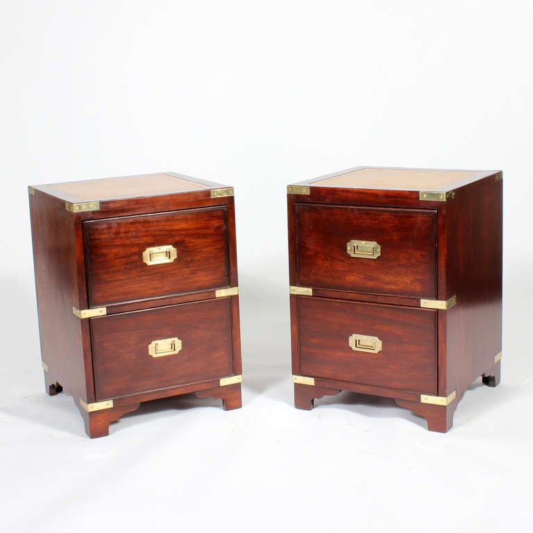A hard to find pair of campaign style 2 drawer chests or tables with tooled leather tops, bracket bases, brass strapping and recessed hardware, in mahogany. Great proportions.

fshenemaderantiques.com
Campaign and more on a professional website.