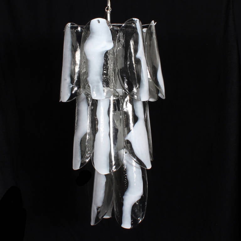 A Mazzega, 1970s Italian chandelier or light fixture. Three-tiered Murano handblown clear to white glass leaves hanging over a chrome plated metal frame. Nice size, with lots of drama. Professionally cleaned and wired. Accepts 6-25 watt torpedo