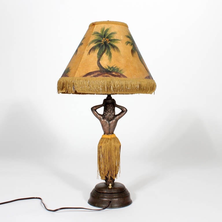 Rare, whimsical, vintage electric patinated metal hula girl with hand-painted tropical, fringed shade, and matching fringed skirt. Turn her on and be hypnotized by her sensual gyrations. Newly wired.