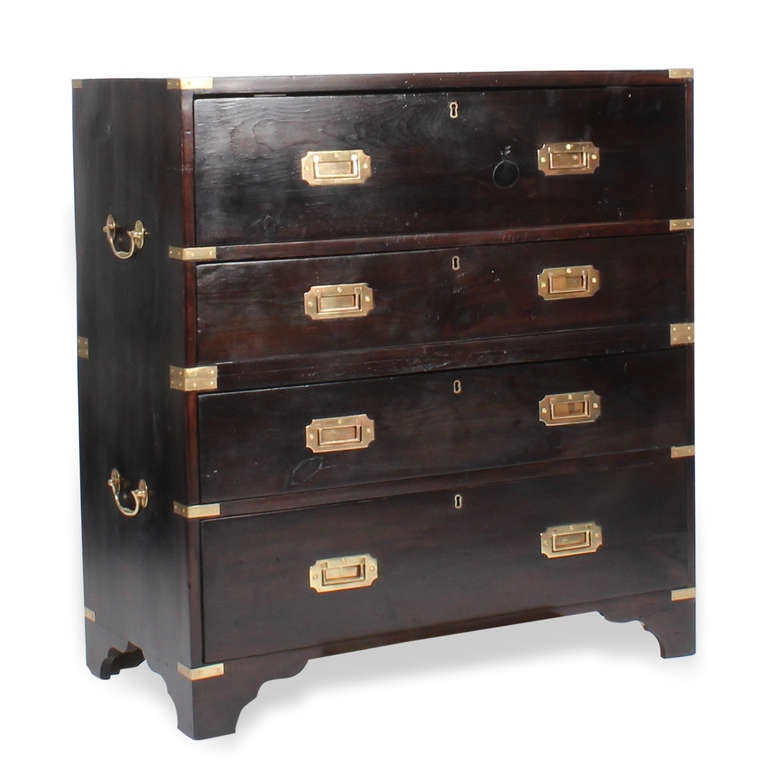 A 2 piece campaign style 4 drawer chest with a drop down secretary drawer,  tooled green leather writing surface, 3 drawer and letter slot interior. Stained pine, with recessed brass hardware, brass strapping, 2 side mounted carrying handles, and a