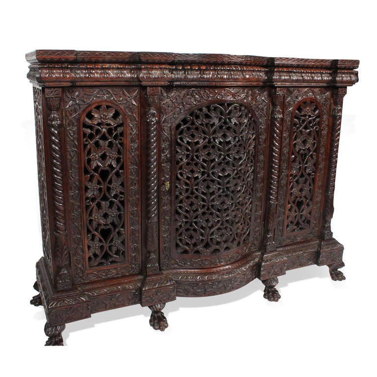 Wonderful carved Anglo Indian 3 door sideboard or console, with extensive foliate carving, rope turned quarter columns, and animal paw feet. The top lifts off for ease of moving.
Probably rosewood. Rare and old.

Anglo Indian and more