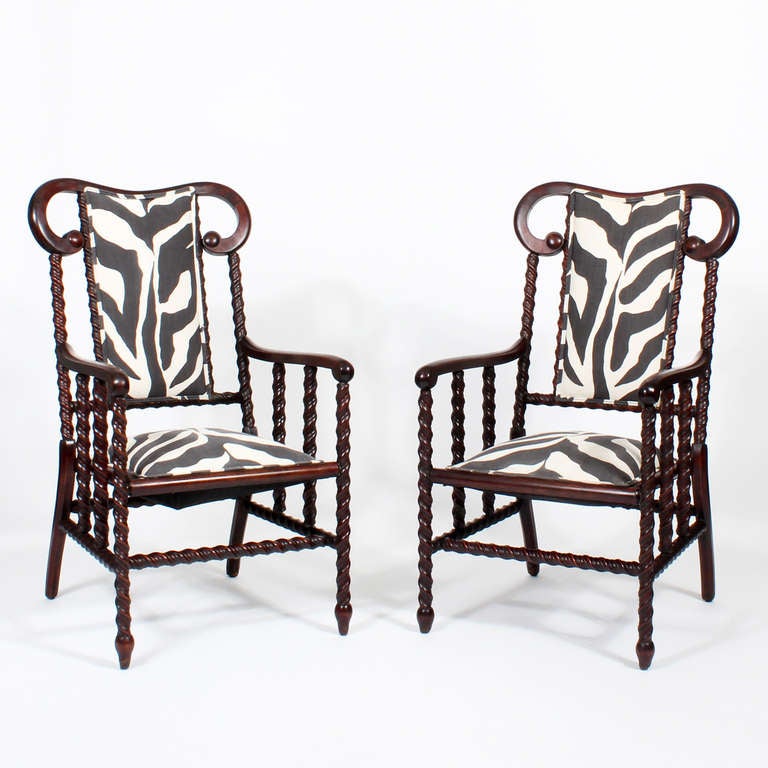 A pair of 19th C arm chairs by George Hunzinger, the eclectic and innovative American furniture maker, working in the New York City in the late 19th C.  Spiral turned legs, arms, spindles and stretchers, reminiscent of the spool turnings, popular at