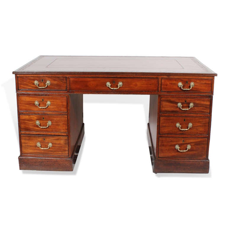 This is a lovely Georgian partners desk in mahogany, one side with 3 drawers above banks of drawers, the other side with 3 drawers above 2 doors.  A great red tooled and gilt leather top, nice choice of graining on the doors, cock beading on the