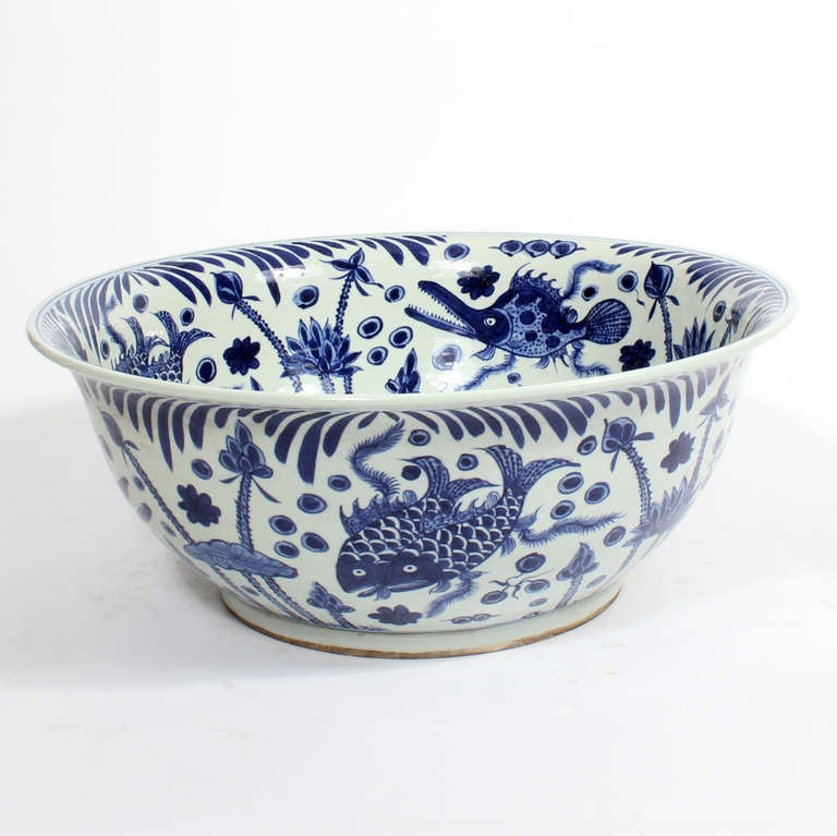This is a huge blue and white Chinese export porcelain bowl, with fish and foliate motifs. Perfect for a center or dining table.


