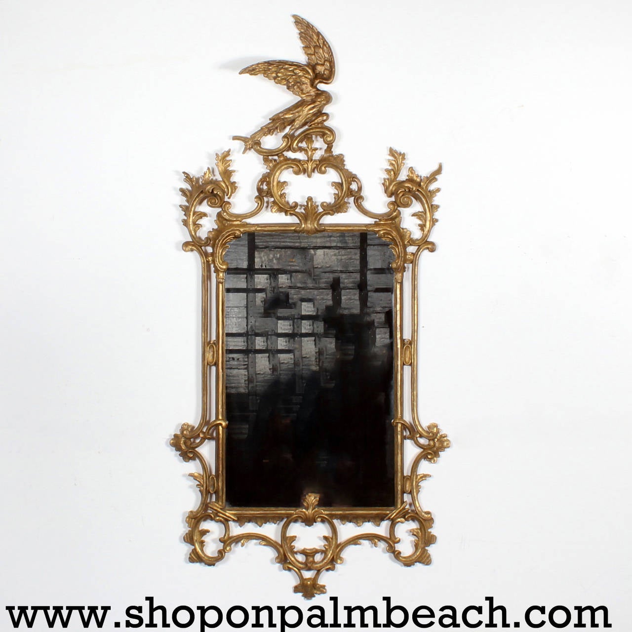 An incredible find, a true mirrored pair of carved and gilt late 18th-early 19th century. Georgian mirrors each with opposing Ho Ho birds and extensive scrolling motifs, in the Chinese Chippendale manner. Most notable are the open winged Ho Ho