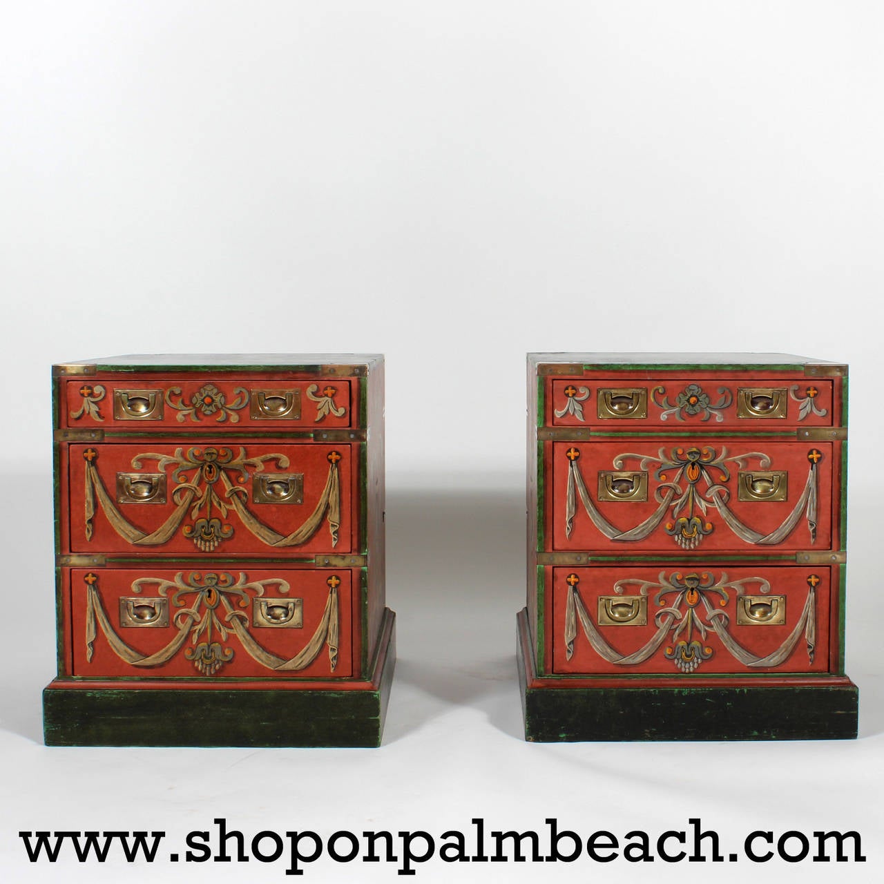 An amazing pair of trompe l'oeil decorated three-drawer Campaign nightstands or end tables, painted on three sides with a floral and drapery motif on a regal red background, with ebonized tops and bases, block feet and Campaign hardware. Campaign in