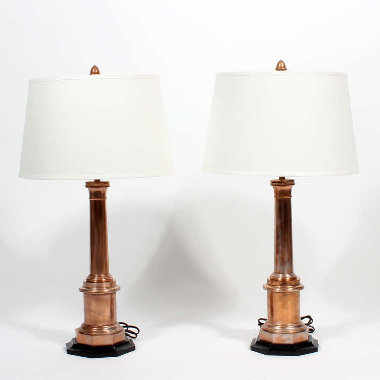 A pair of custom made copper lamps, with octagonal shaped ebonized bases, turned columns and custom copper finials.
Definitely a marine flavor, somwhat reminiscent of lighthouses, in form. Newly wired.

