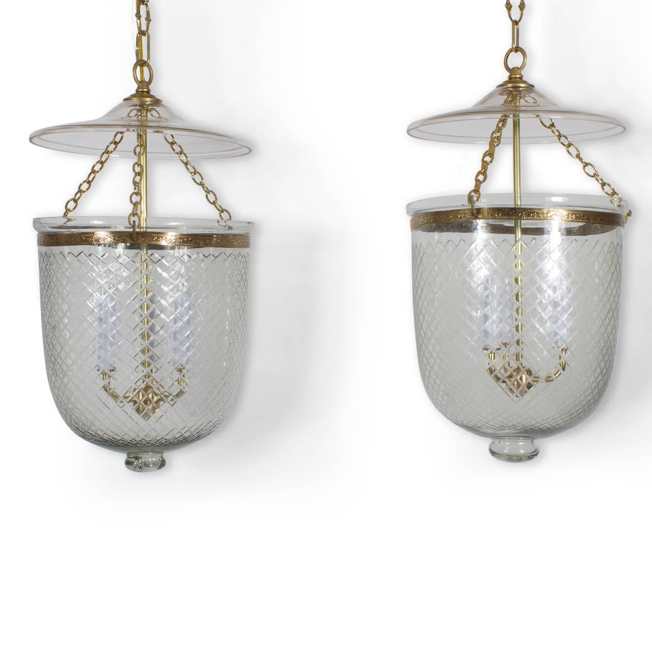 Used in the West Indies, India and England, these vintage, cross cut glass and brass bell jar pendant lights, or hurricane chandeliers  have a classic ancient chandelier form, they add romance and mystery to all decors. Timeless lighting still
