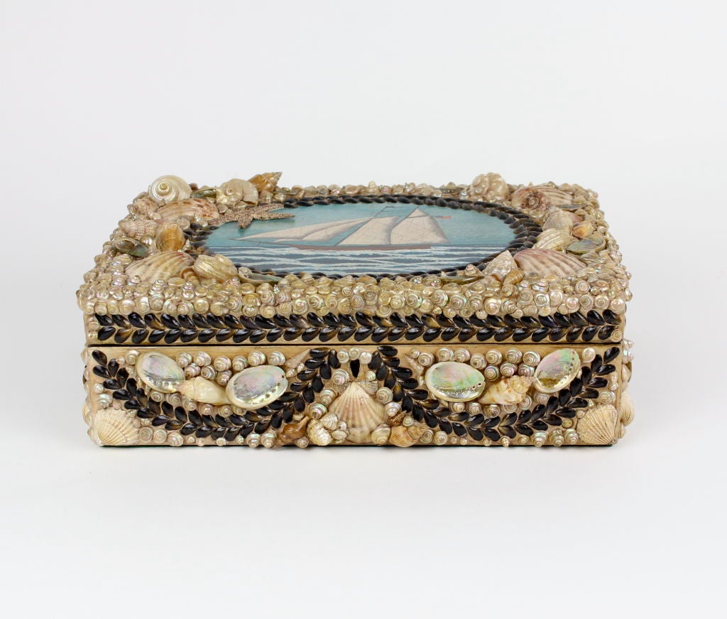 Shell encrusted box with a painting of a clipper ship. The shells and painting are contemporary, the box is antique.<br />
<br />
Please check out our website at fshenemaderantiques.com