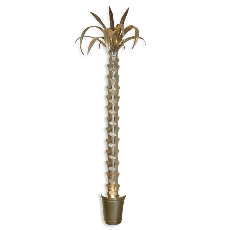 A pair of large metal palm tree wall sconces, with spot lights in the pots and 3 chandelier lights in the fronds.  Custom made, with deliberate etching to accent the trunk and fronds. Extremely decorative.

Vintage palm trees are a passion at