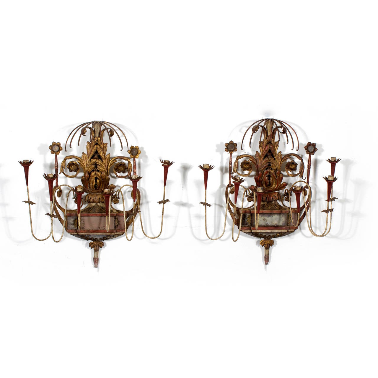 A Fine and important pair of 19th century Italian neoclassical style six-arm wall sconces. Composed of a decorative cascading top, over worn, well patinated gilded metal acanthus leaf backplate, spiraling to paired gilt flowers, all above a wood and