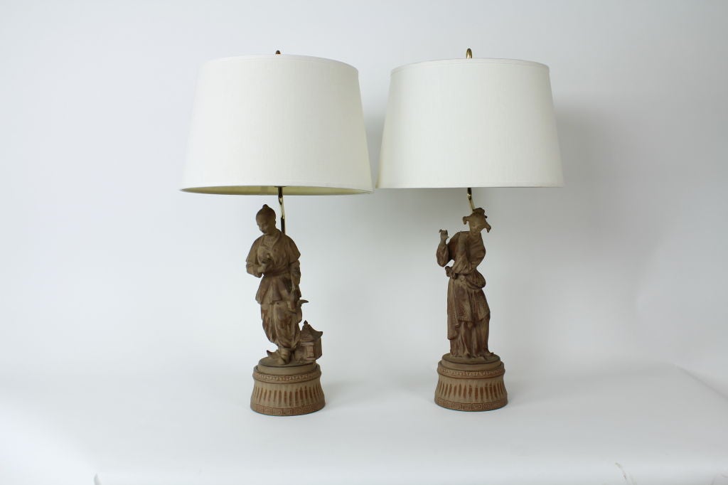 A pair of very stylish and elegant terra cotta male and female figural lamps, in the chinoiserie manner. Newly wired.

 