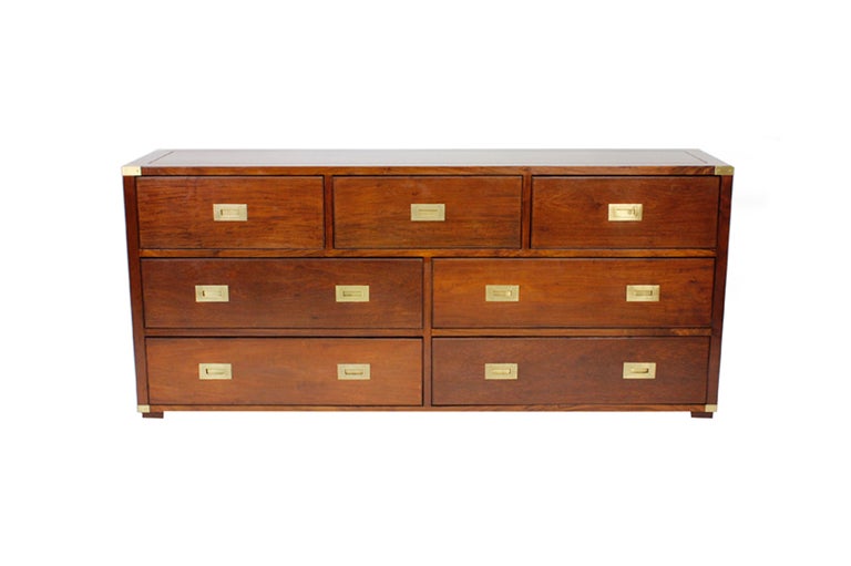 A long double dresser or sideboard in the campaign manner, with large recessed brass hardware. Mahogany.

For more great campaign pieces: fshenemaderantiques.com
