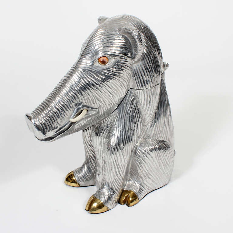 This wart hog wine cooler makes you laugh. He sits so solidly, with his long snout, carnelian eyes, and brass hooves. His head is hinged, allowing for a wine bottle. He will add a sense of whimsey and humor to any get together. Stamped and dated,