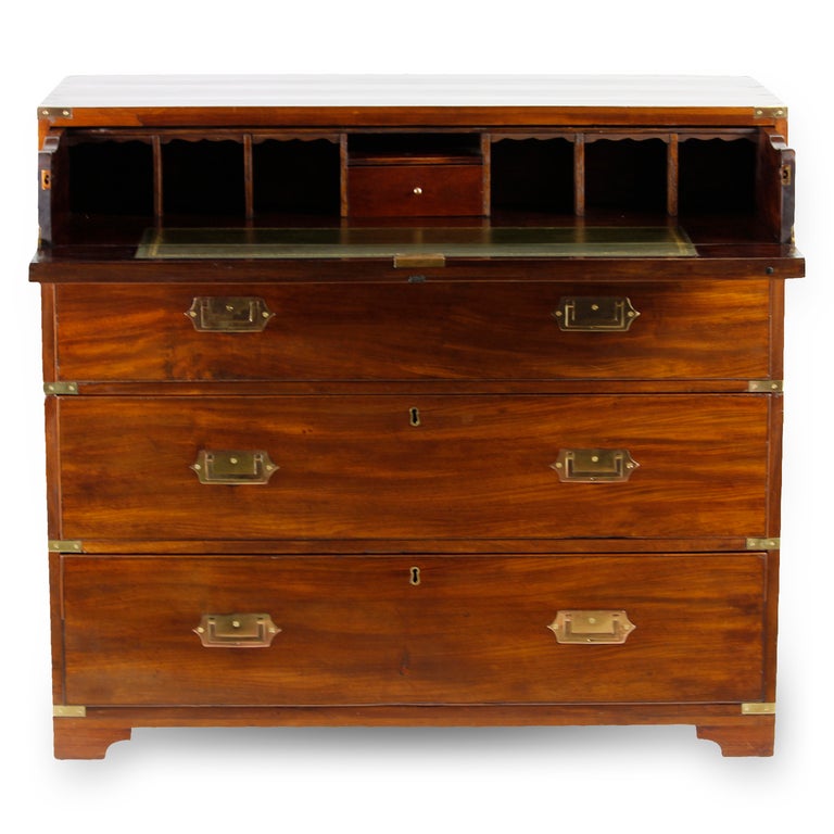 A beautiful 2 part campaign chest with a faux 2 drawer top drawer, dropping down to reveal a secretary interior with tooled green leather inset, pigeon holes, and a single drawer. Well grained mahogany, and a bracket base, make this a very special