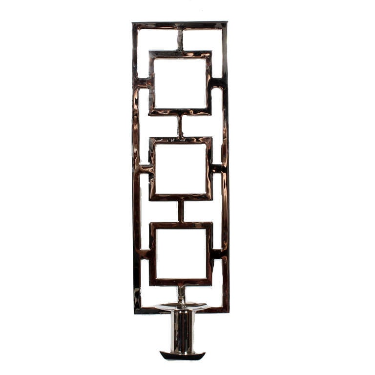 A pair of custom chrome plated brass candle wall sconces with an interlocking squares design, in the modern manner. Custome chrome plated at a later date, these sconces are reflective and decorative.