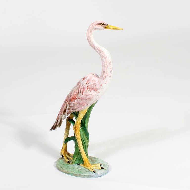 A pair of very elegant porcelain bird figures, in the shape of a flamingo and an egret, both in similar colors. The bird figures are very stately, with dramatic form and coloring. Signed Italy and Birks on the reverse. Birks is a well known high end