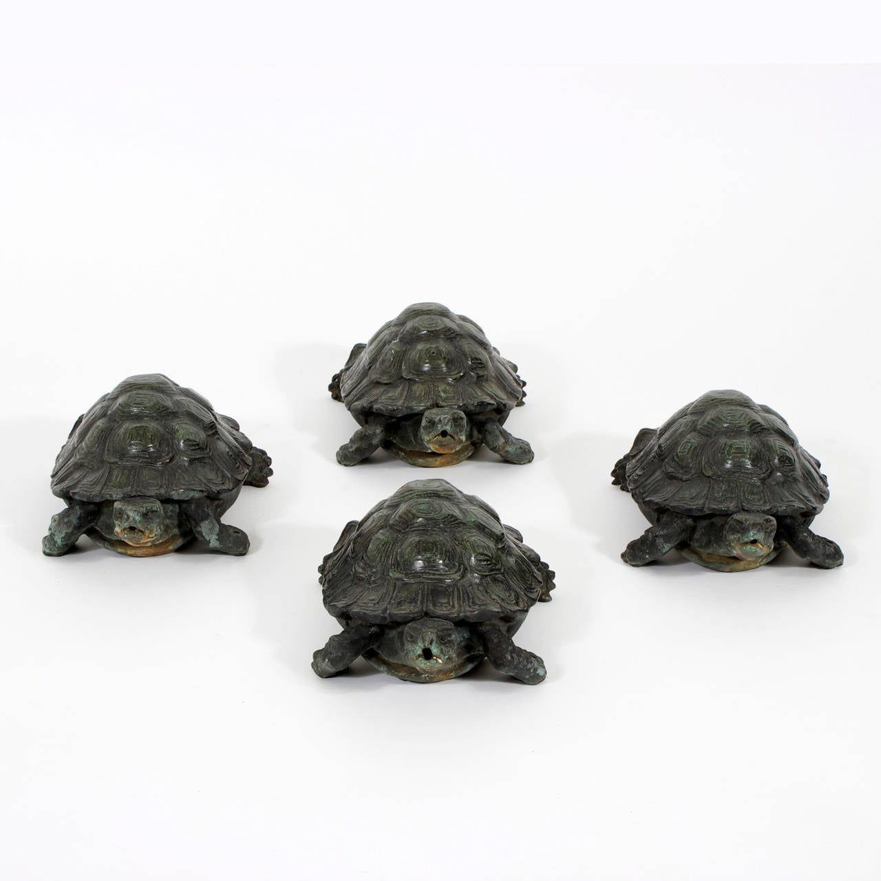 4 vintage bronze turtles or tortoises, cast in life like form and detail, with charming verdigris patina. Once fastened to a fountain, these tortoises have aged to perfection. They can be used outdoors or enjoyed as objects of art.
Priced