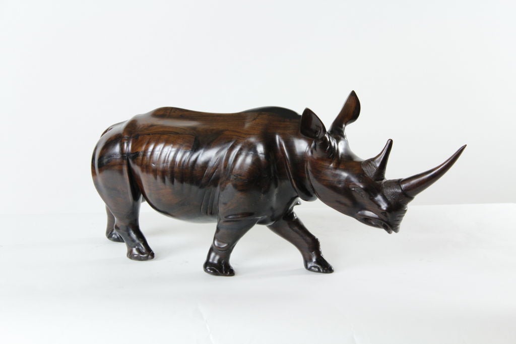 A large sculptural carved rosewood rhinoceros signed Umeme. Great skill and art.