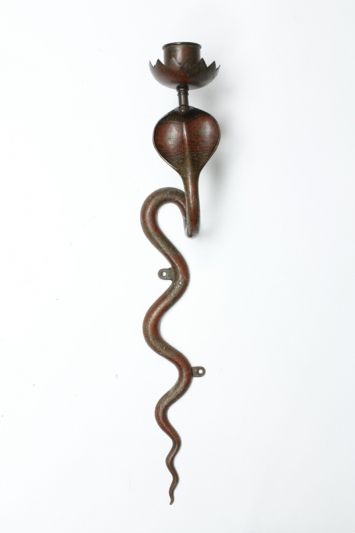 A pair of patinated brass cobra wall sconces from India, with scalloped bobeches and a great vibe. Can be electrified.

