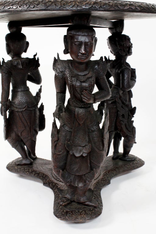 A monumental well detailed Anglo-Indian carved round table, with three large figures of Hindu deities, and smaller figure in the interior. Very finely carved. An excellent example of an Anglo-Indian table.
 