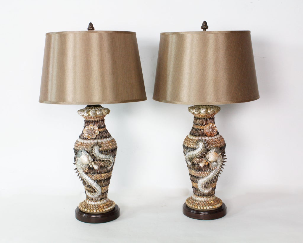 A pair of finely detailed vintage seashell lamps, with wood bases.Some of the shells used on the lamps are no longer available.

Visit our website to see more examples of exotic lamps and decorative pieces:
www.fshenemaderantiques.com